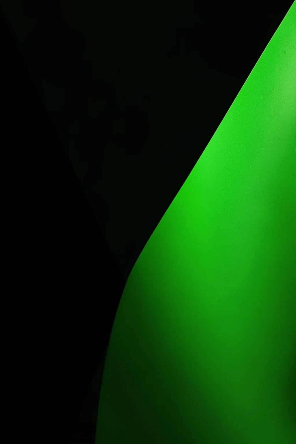 Deep Green Form. A smooth bright-green curved form sweeps diagonally across a nearly black background.