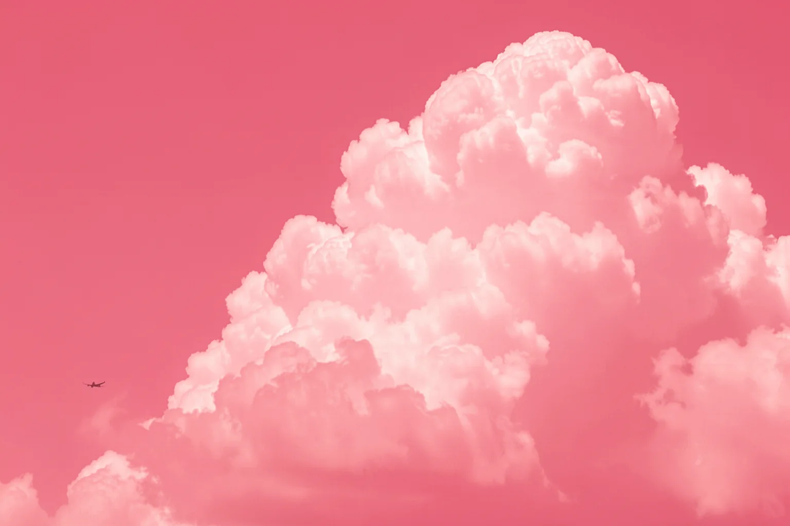 Pastel Sky Flight. A small airplane crosses a pastel pink sky filled with soft clouds.