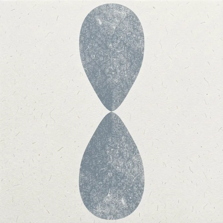 Blue Symmetry. Two pale gray textured ovals meet in a vertical figure-eight arrangement on cream.