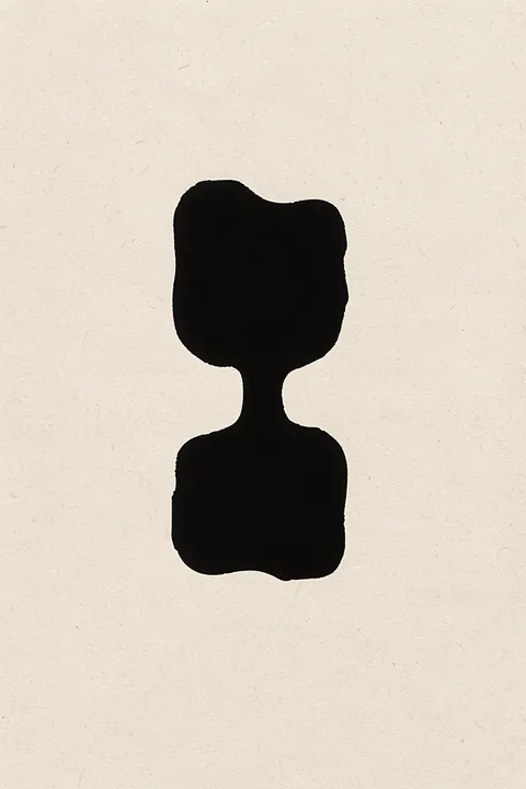 Abstract Organic Shape. A single irregular black organic silhouette sits centered on textured cream paper.