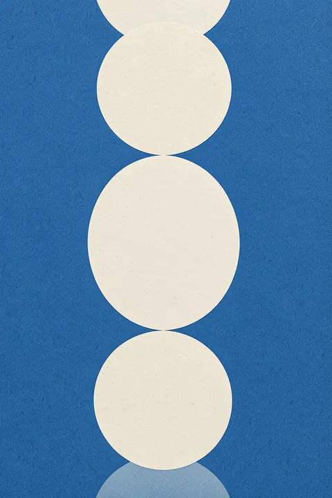 Geometric Blue Vase. Three cream semicircles and circles are stacked vertically against a textured blue background.