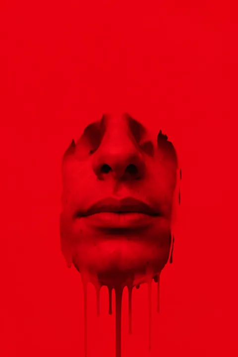 Bold Red Face. A close-cropped face appears in monochrome red, with dark paint-like drips extending below the chin.