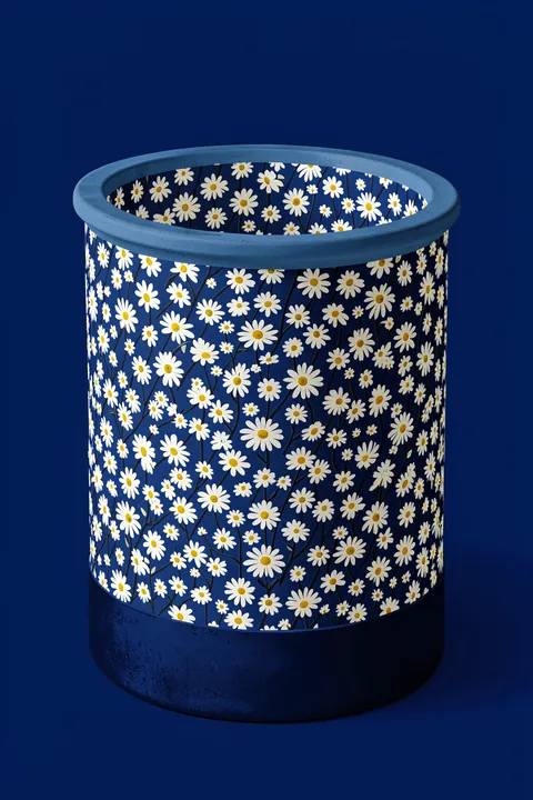 Blue Daisy Vase. A dark blue cylindrical vessel covered in small white daisies stands against a solid navy background.