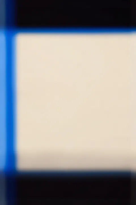 Blurred 13. Softly blurred dark navy and black bands frame a large pale cream center, with vivid blue along the left edge.