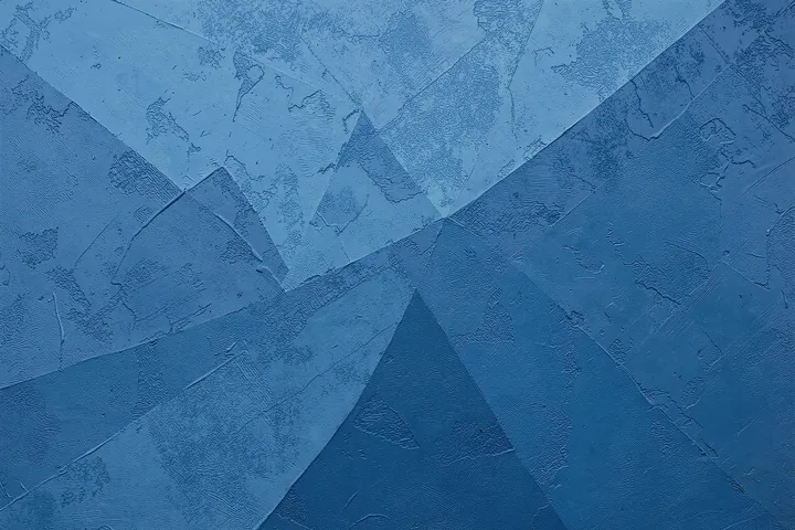 Abstract Blue Angles. Low-contrast angular shapes overlap across a textured field of deep and pale blues.