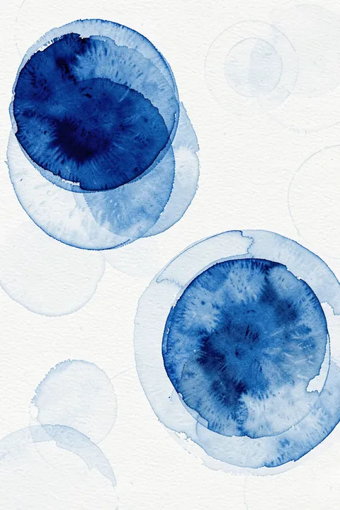 Fluid Indigo Circles. Two deep indigo watercolor circles overlap with lighter blue washes on textured white paper.