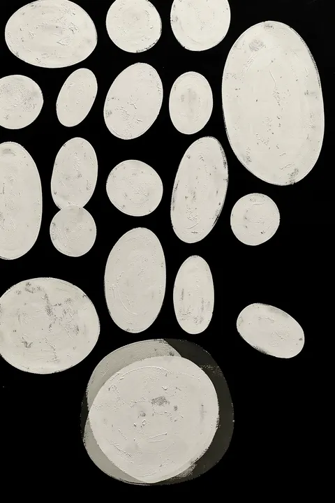 Monochrome Ovals Pattern. Irregular white painted ovals of varied sizes are scattered across a black background.