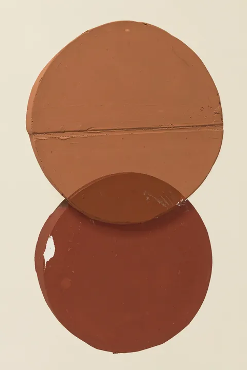 Dual Circles Harmony. Two overlapping terracotta circles with subtle texture are centred on a pale background.