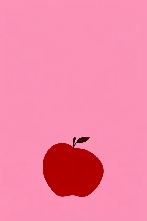 Crimson Simplicity. A simple red apple with a dark stem and leaf sits low on a plain pink background.