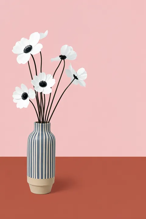 Blush Floral Vase. Five simple white flowers with dark centers rise from a blue-and-white striped vase against blush pink.