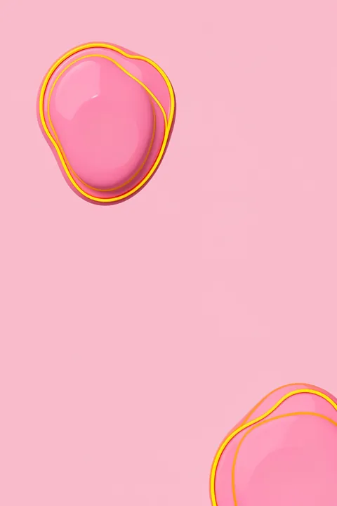 Good lookin. Two glossy, rounded pink forms outlined in yellow sit apart on a soft pink background.