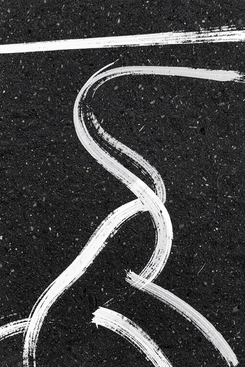 Monochrome Paths. Flowing white brushstrokes trace winding paths across a textured charcoal ground.